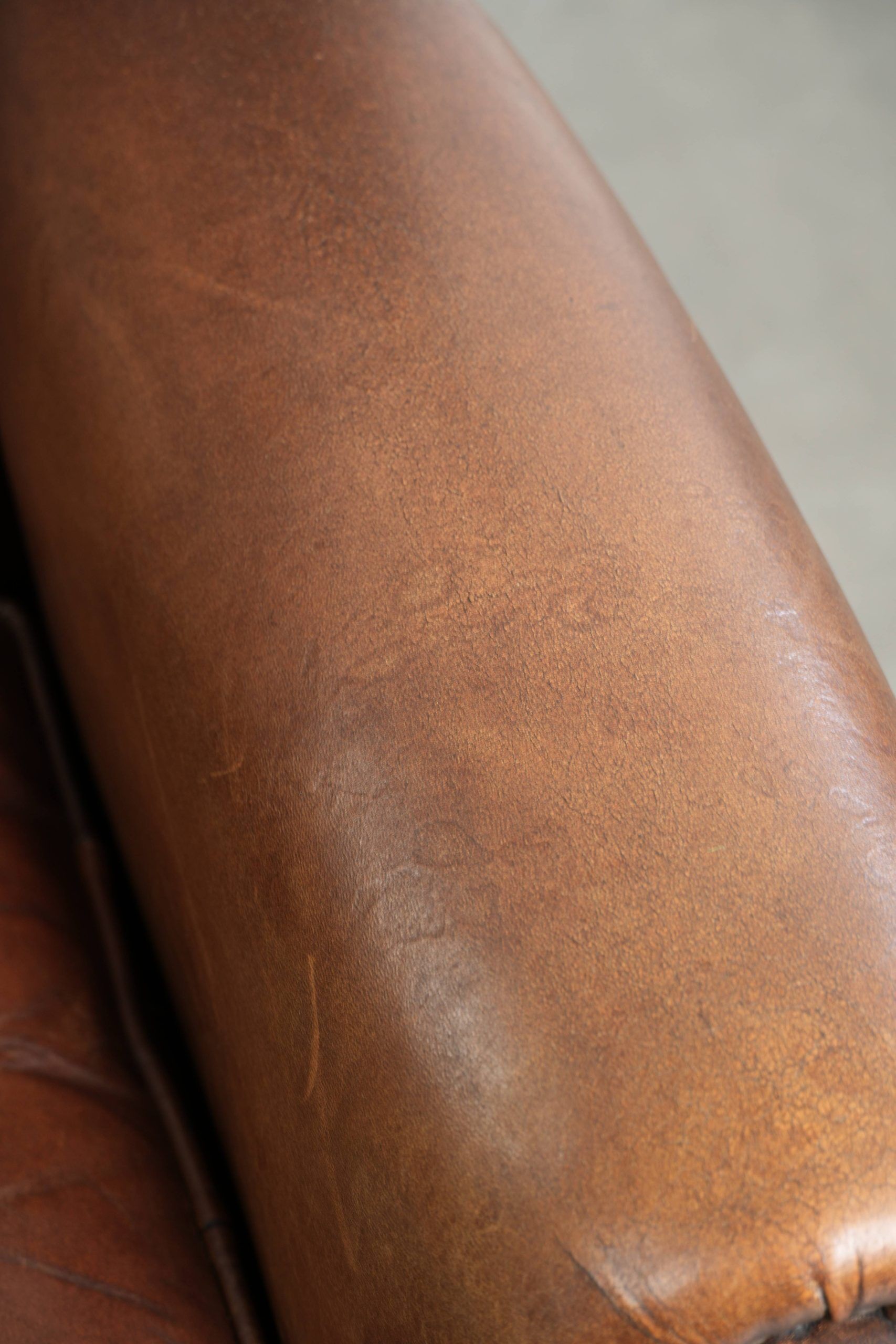 Subtle dark brown sheepskin wingback armchair with a timeless look subtle