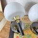Pair of wall sconces with brass torch and white glass globe.