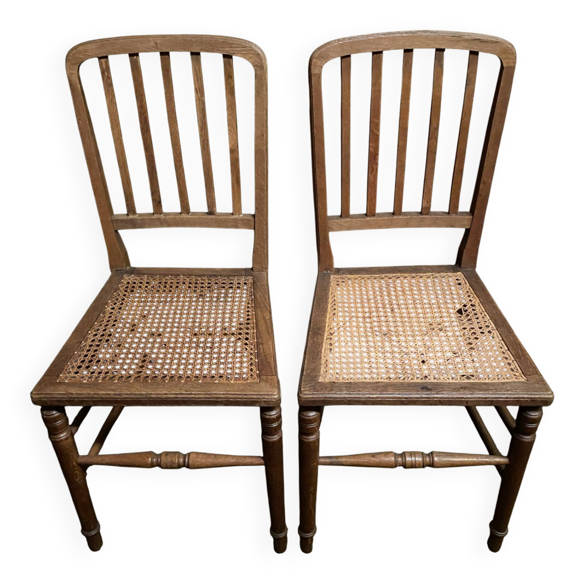 Set of 2 antique wooden chairs with caned seats.