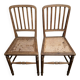 Set of 2 antique wooden chairs with caned seats.