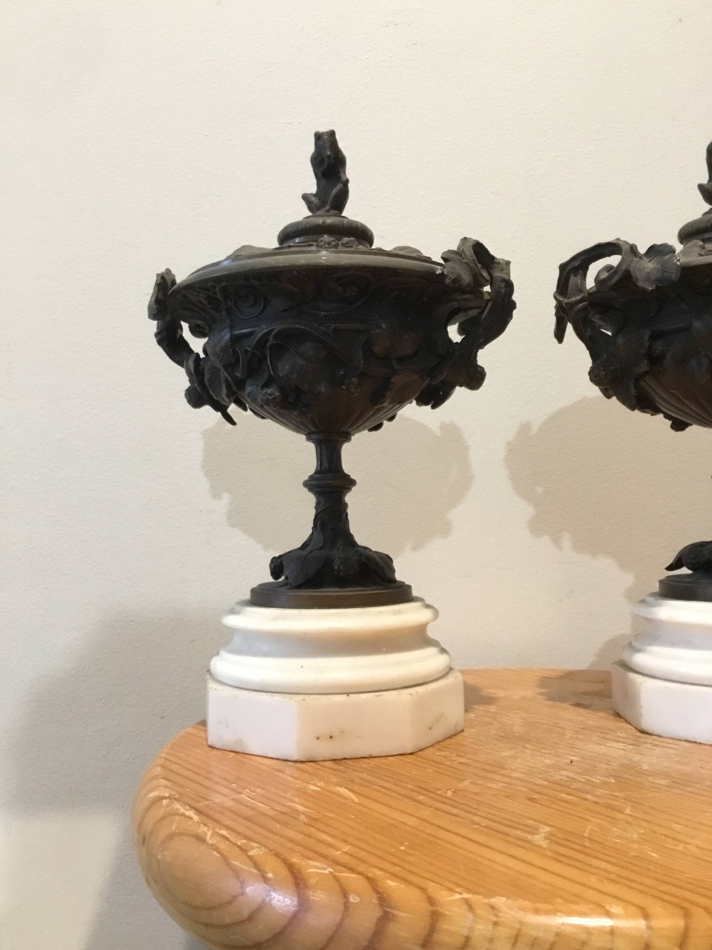 Bronze fireplace garnitures with marble base depicting leaves.