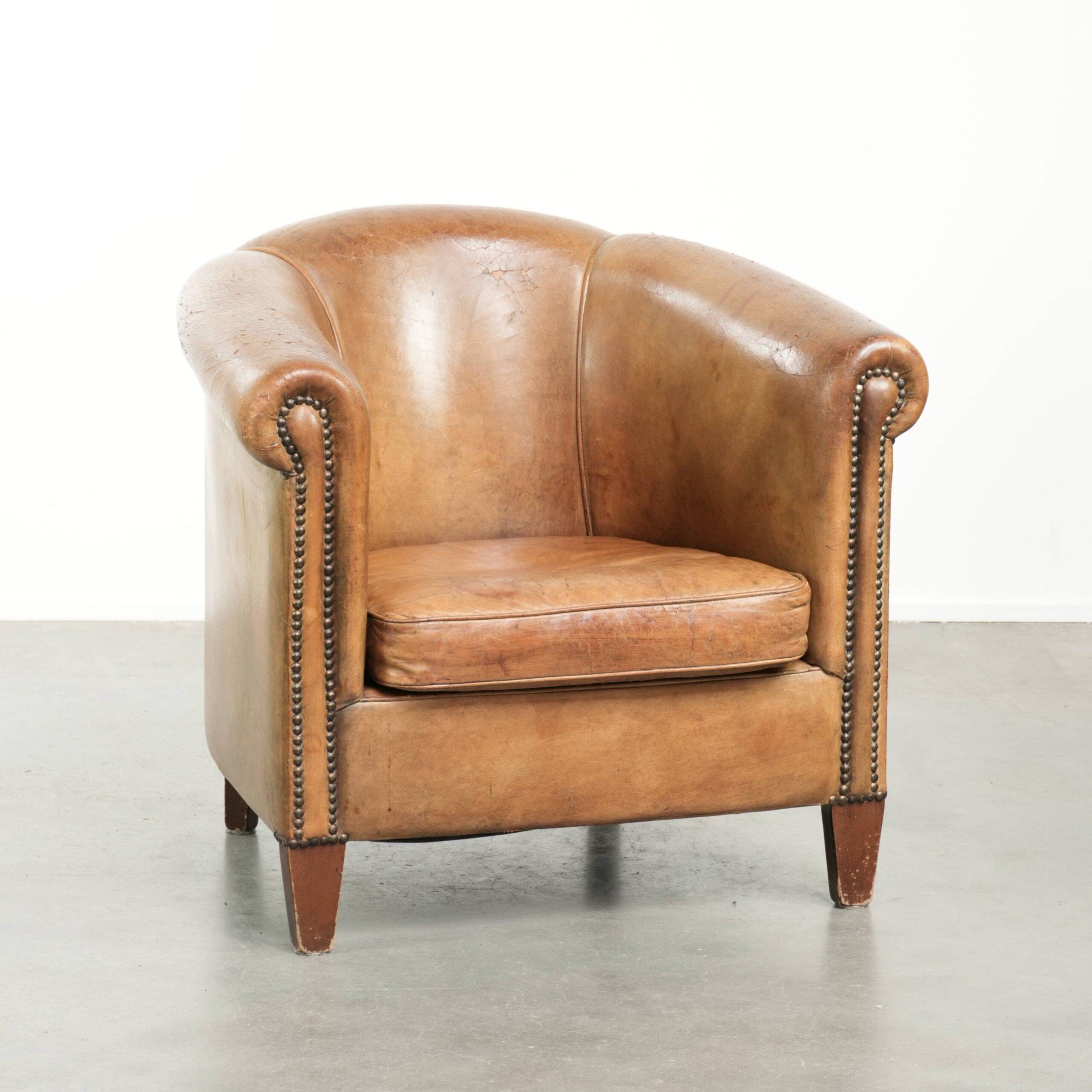 Vintage sheepskin club armchair finished with decorative nails