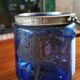 Old ice or biscuit bucket made of golden decor blue glass