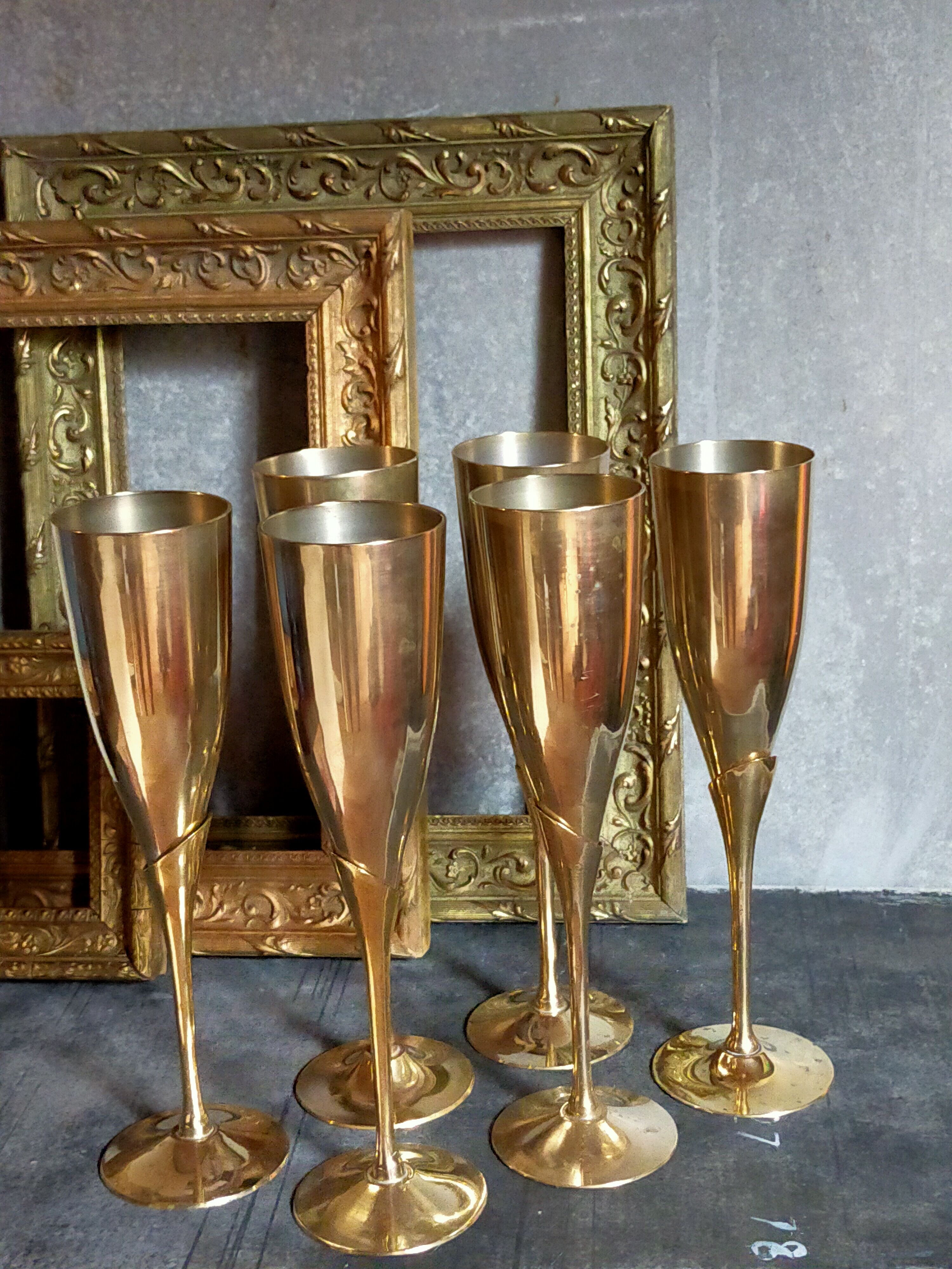 Six brass champagne coupes