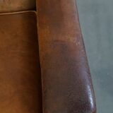Characteristic antique sheepskin leather armchair with beautiful details and a unique design
