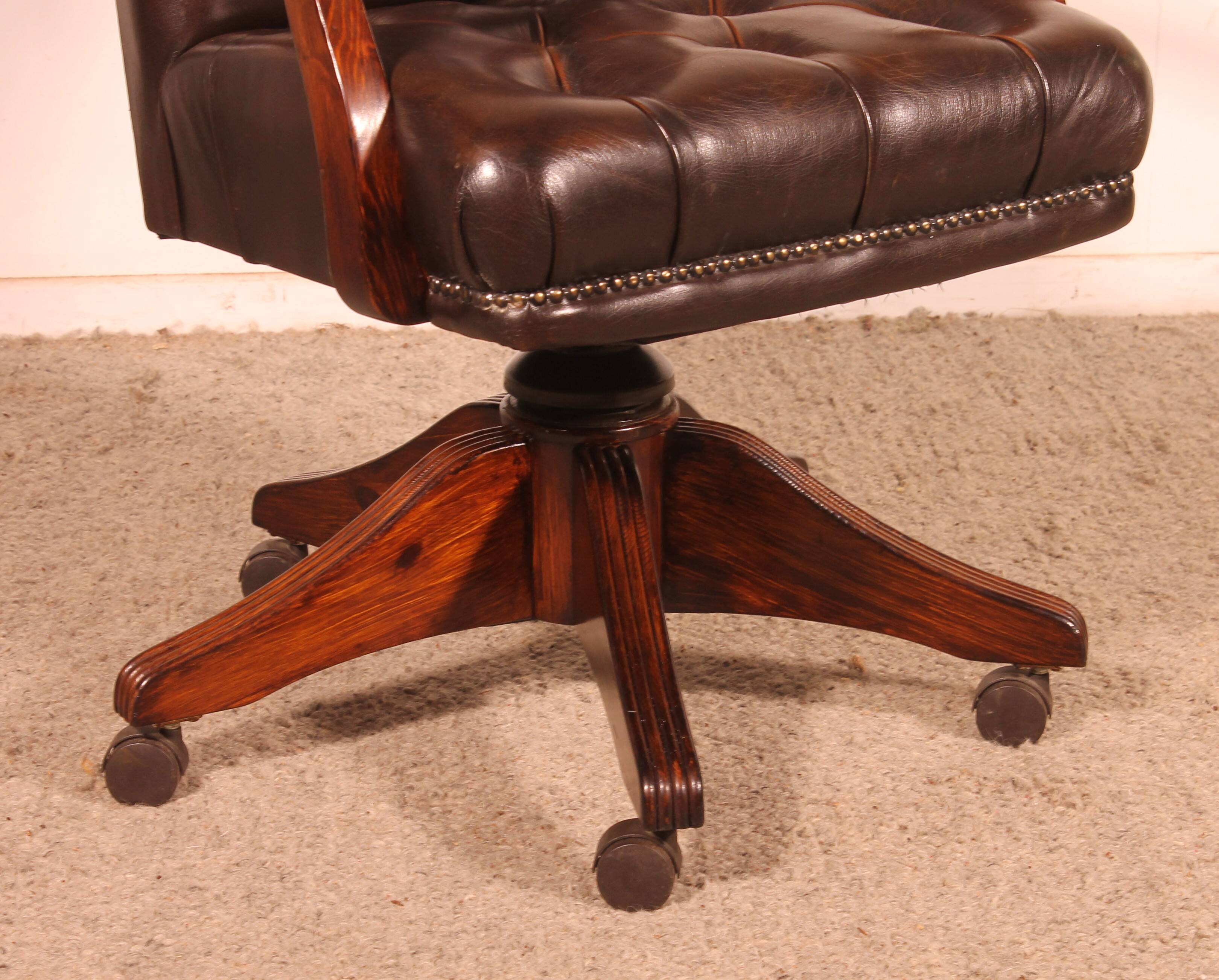 Office chair known as a director's chair in wood and tufted leather.