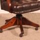 Office chair known as a director's chair in wood and tufted leather.