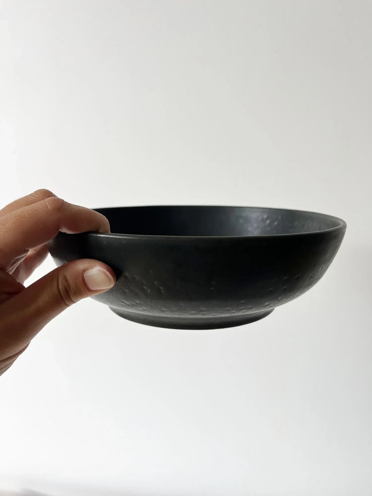 Round vintage black ceramic catchall.