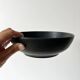 Round vintage black ceramic catchall.