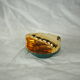 Porcelain pocket tray in the shape of a golden scallop shell with duck green background from the 50s/60s