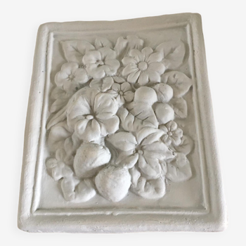 Decorative plaster wall piece representing flowers in relief