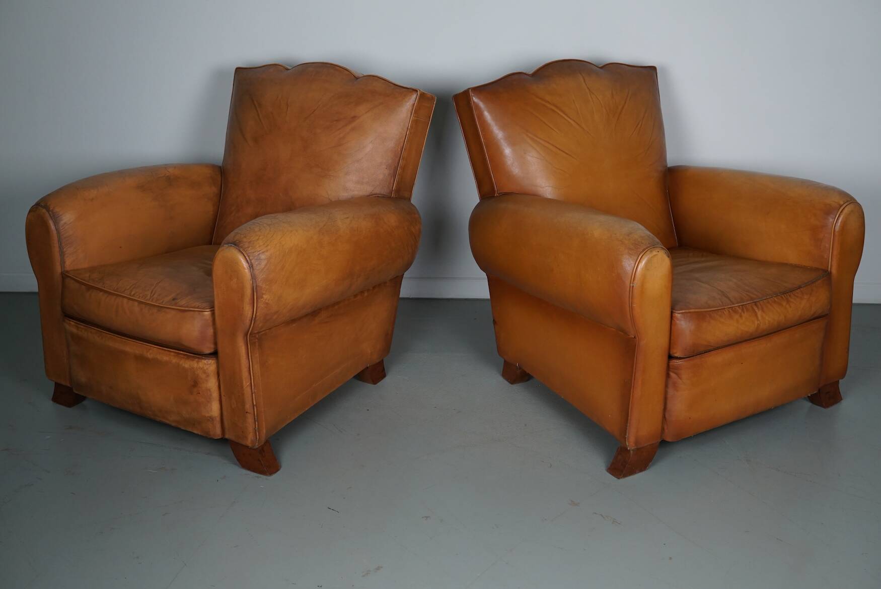 Pair of French Cognac Moustache Back Leather Club Chairs, 1950s