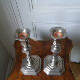 Pair of silver-plated metal candlesticks with cut sides