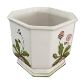 Cover - white ceramic pot decorated with stylized flowers.