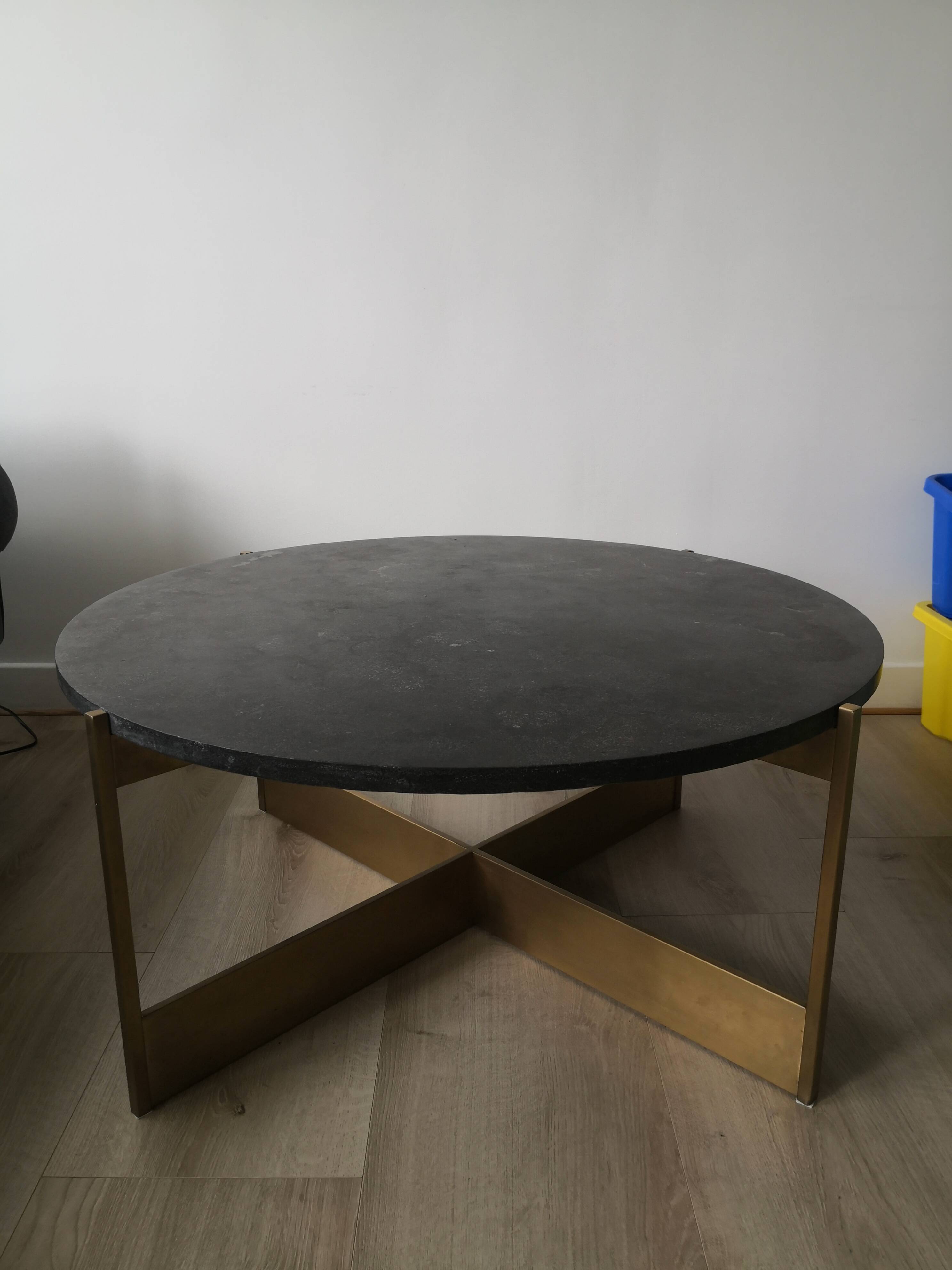 Round coffee table with a metal base and a blue stone top.