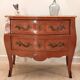 Louis XV style commode with two drawers and a pink marble top.