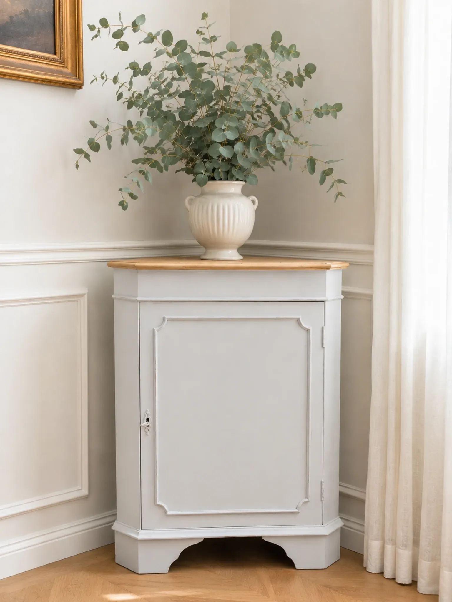 Vintage English corner cabinet enhanced in pearl grey, wooden top.