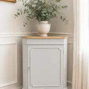Vintage English corner cabinet enhanced in pearl grey, wooden top.
