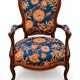 Restored Louis-Philippe cabriolet armchair, blue and orange floral fabric.