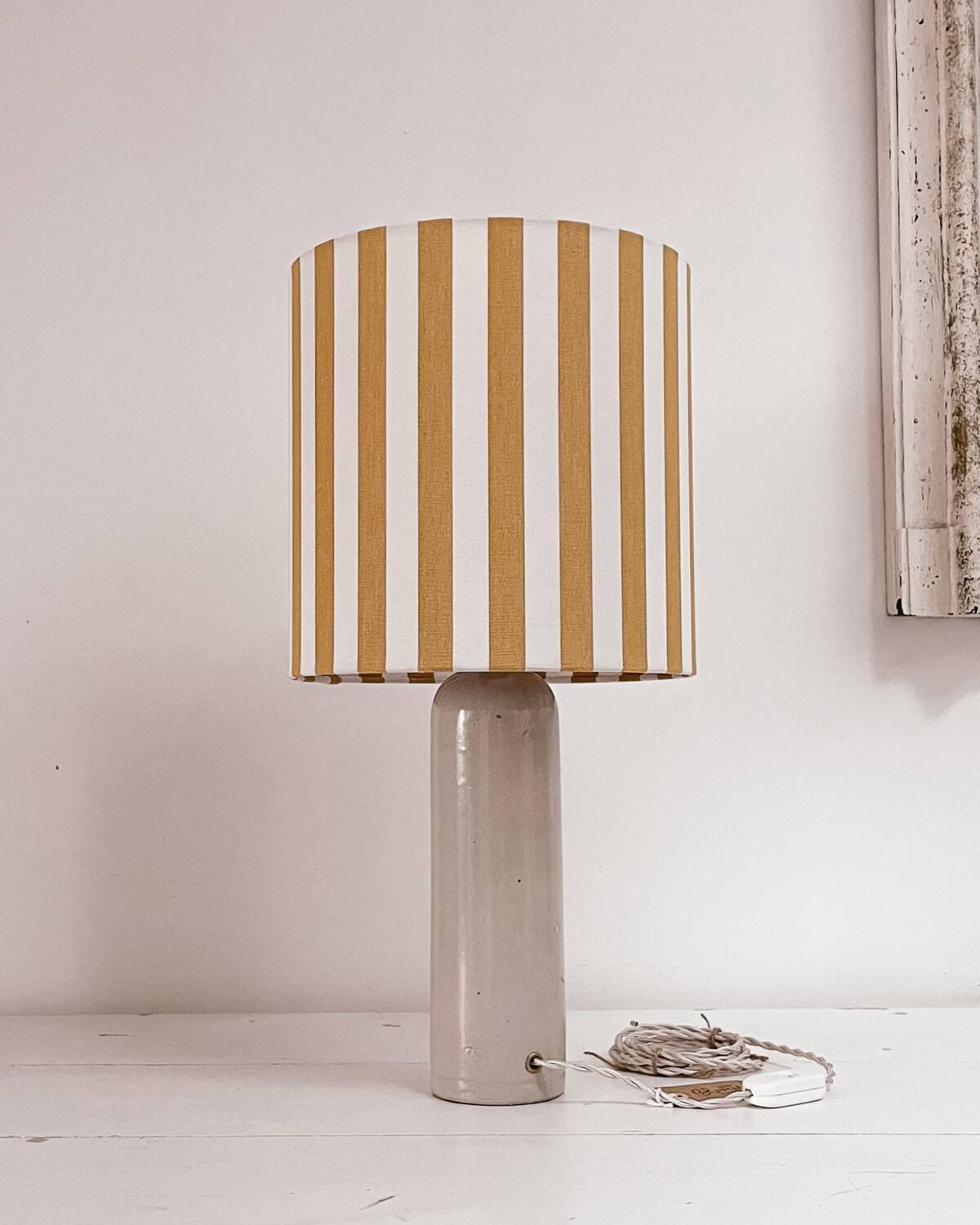 Sandstone lamp and striped lampshade