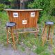 Vintage rattan bar with 1960s earthenware tile decor with 2 stools