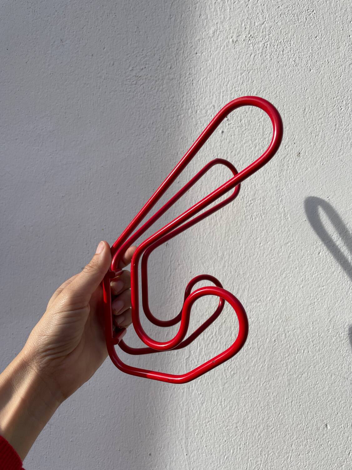 Pair of red metal wall hooks
