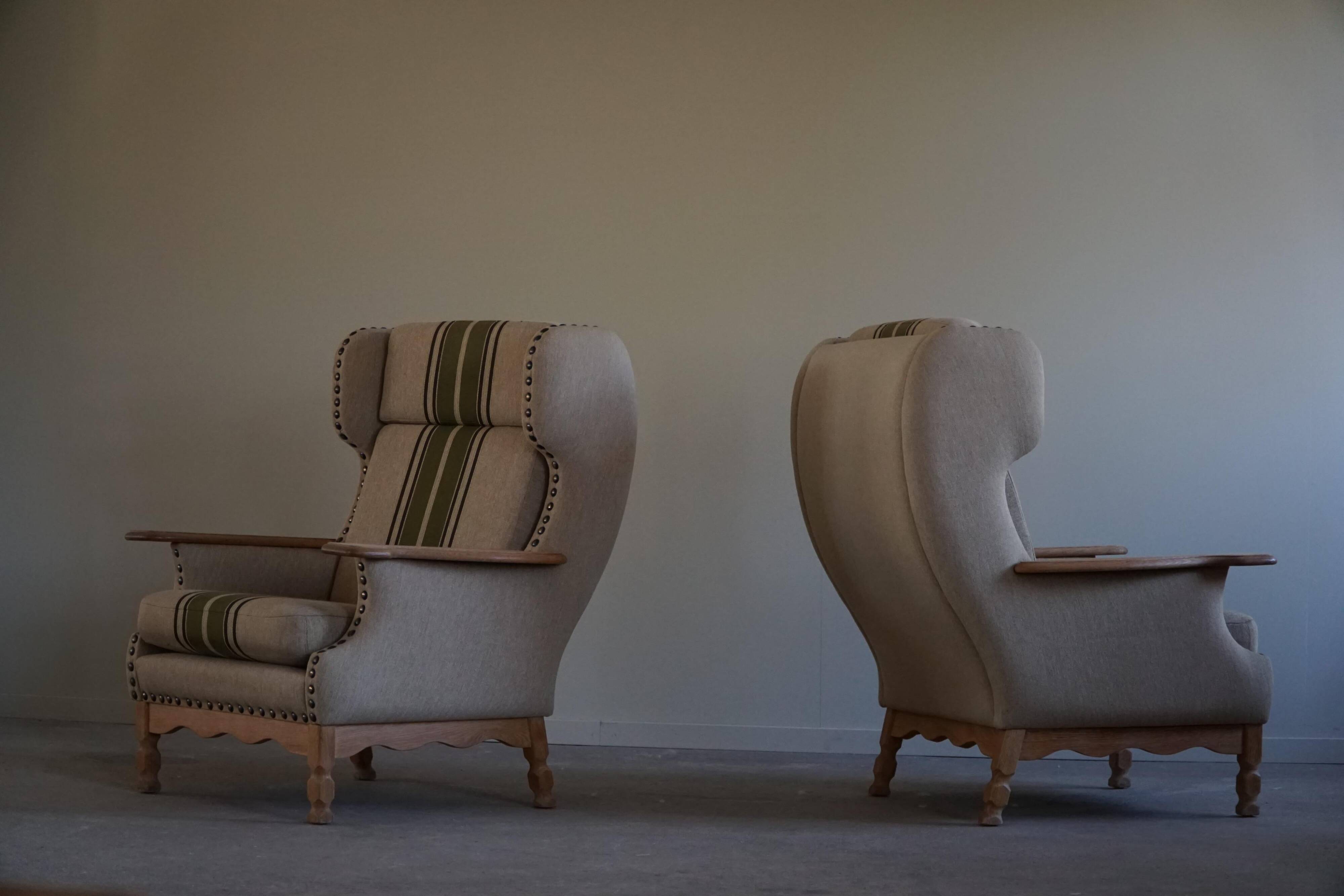 Pair of high-back lounge chairs in modern Danish style in the manner of Henning Kjærnulf, 1960s.