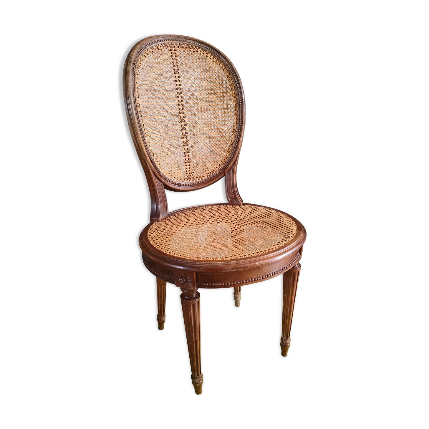 Wooden chair sitting in cannage