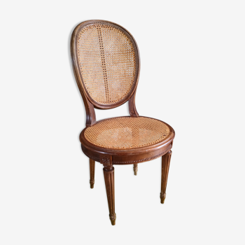 Wooden chair sitting in cannage