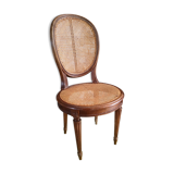 Wooden chair sitting in cannage