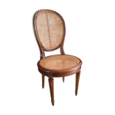 Wooden chair sitting in cannage