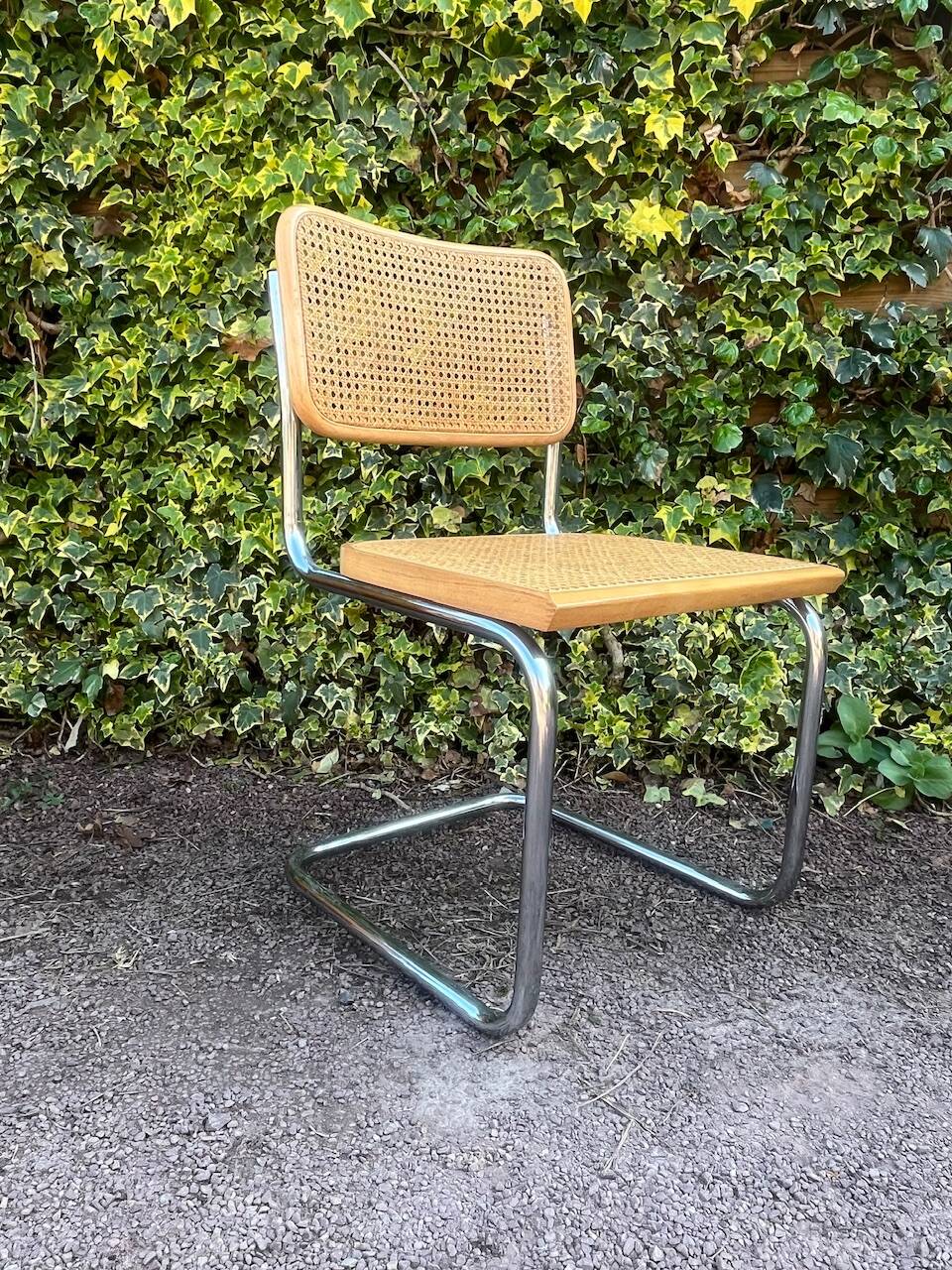 Wooden chair with caning in the style of Marcel Breuer.