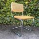 Wooden chair with caning in the style of Marcel Breuer.