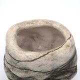 Ceramic vase sculpture decorated with faces and featuring a hole, 1980s.