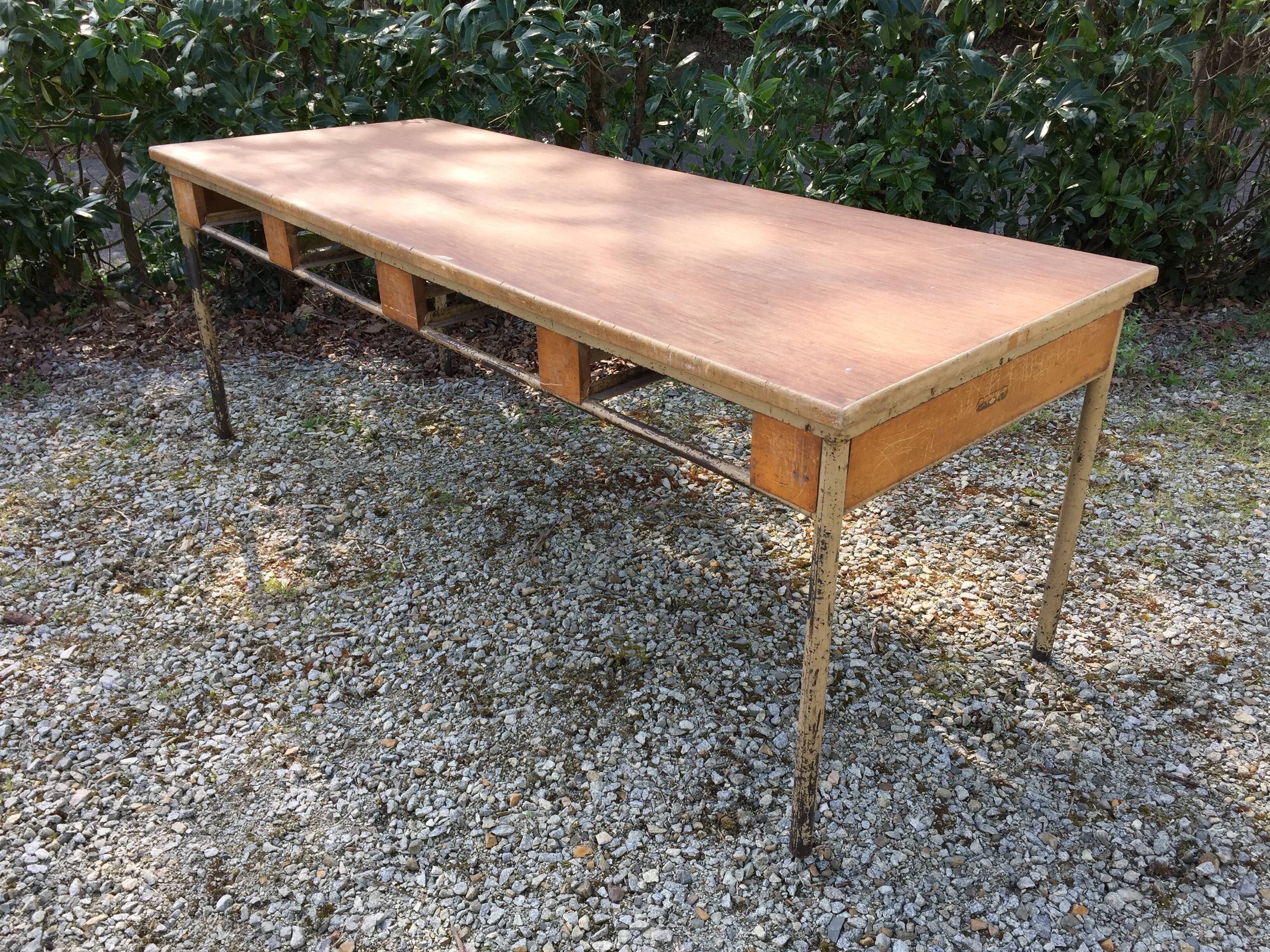 Vintage modernist table with metal tubular base and top covered with oilcloth.