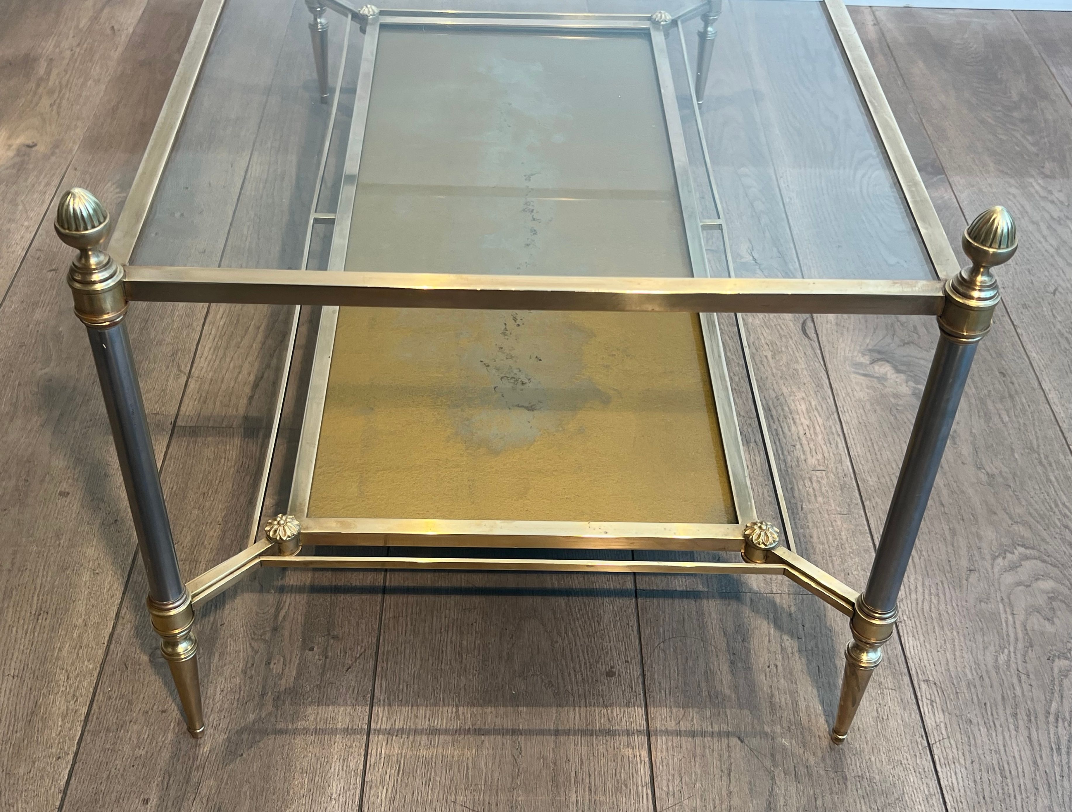Coffee table in brass, brushed steel, glass, and gilded eglomisé mirror from Maison Jansen.
