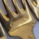 12 Table Forks in gold metal