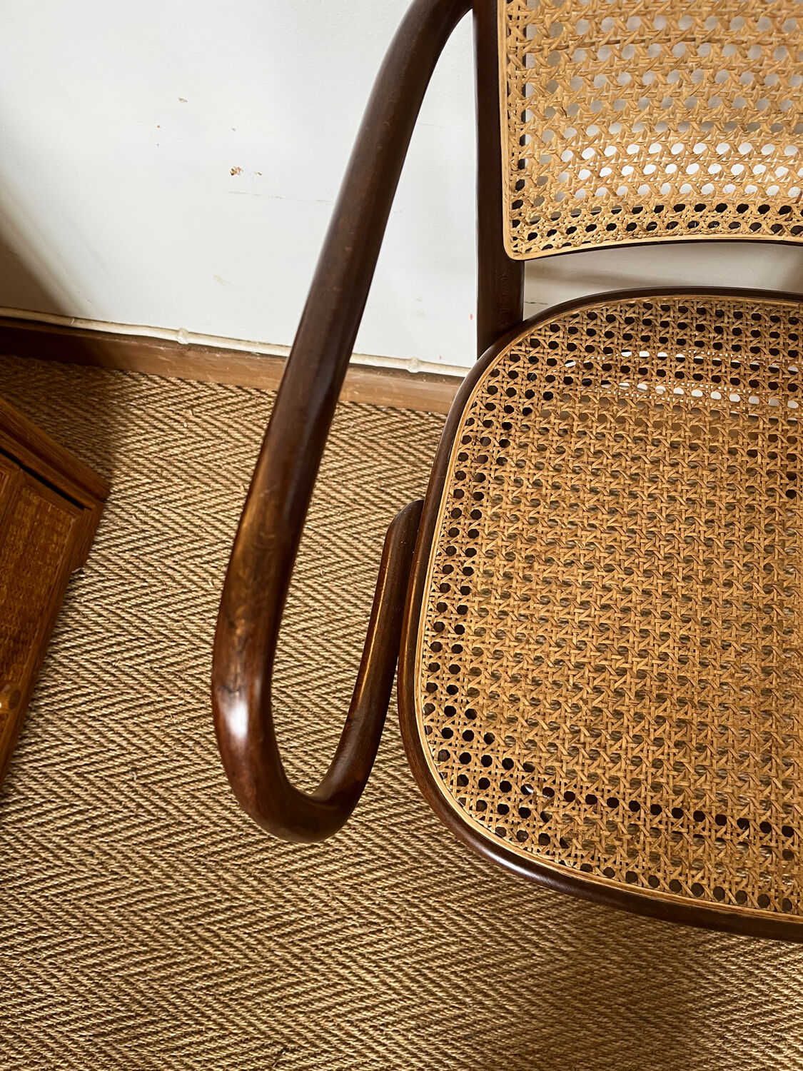 Curved wood and cane armchair
