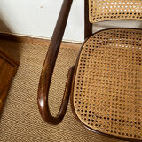 Curved wood and cane armchair