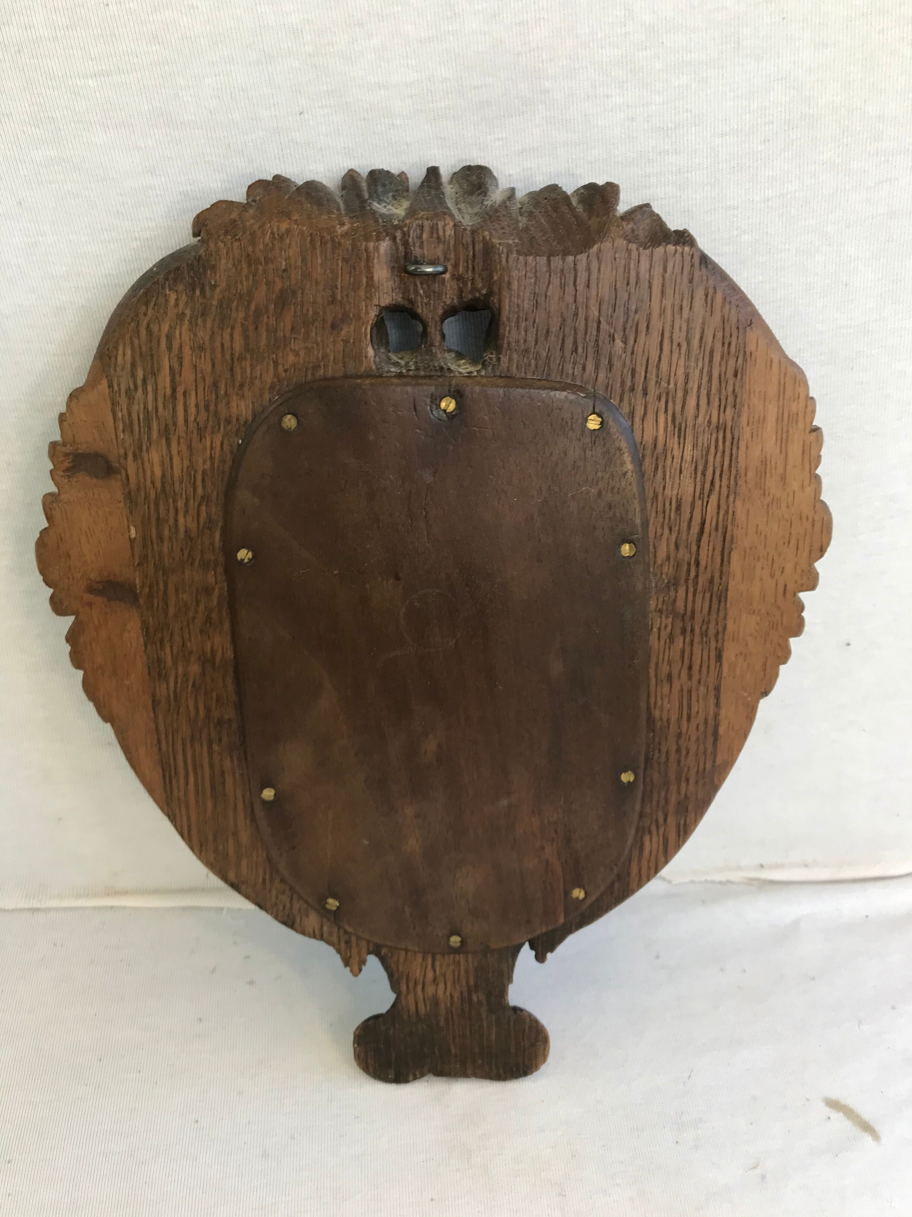Ancient mirror in carved wood, vintage decoration