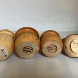 Four solid turned wooden vases