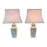 Pair of large cream ceramic table lamps with relief peacocks and fabric shades