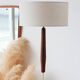 Vintage floor lamp in teak and brass with a cream shade.