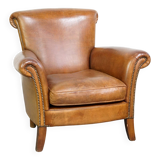 Beautiful and comfortable sheepskin armchair, finished with decorative nailheads
