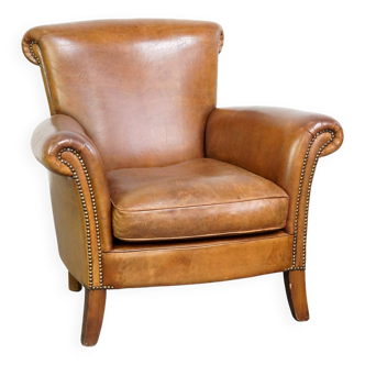 Beautiful and comfortable sheepskin armchair, finished with decorative nailheads