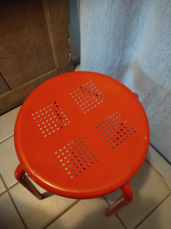 Red patinated metal stool