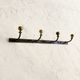 Wall-mounted coat rack with 4 hooks in metal and brass