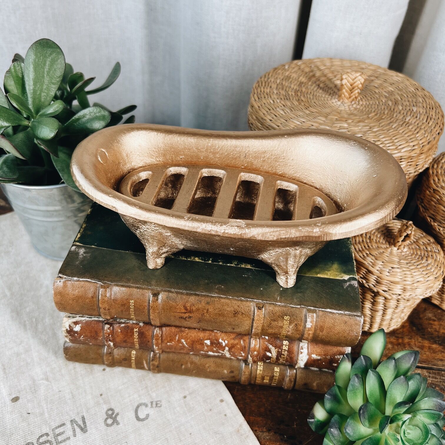 Cast iron soap dish in the shape of a bathtub