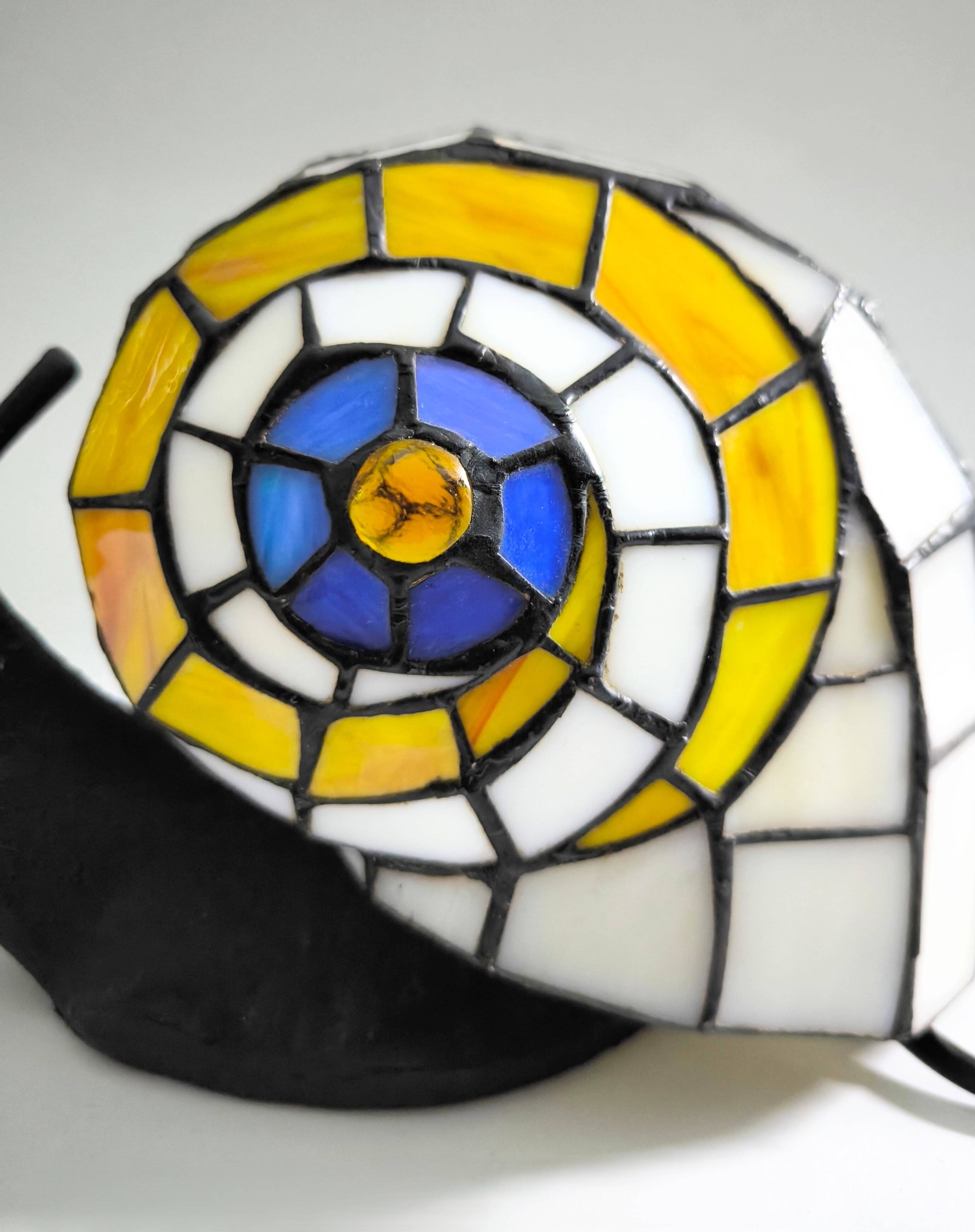 Tiffany-style lamp in the shape of a snail.