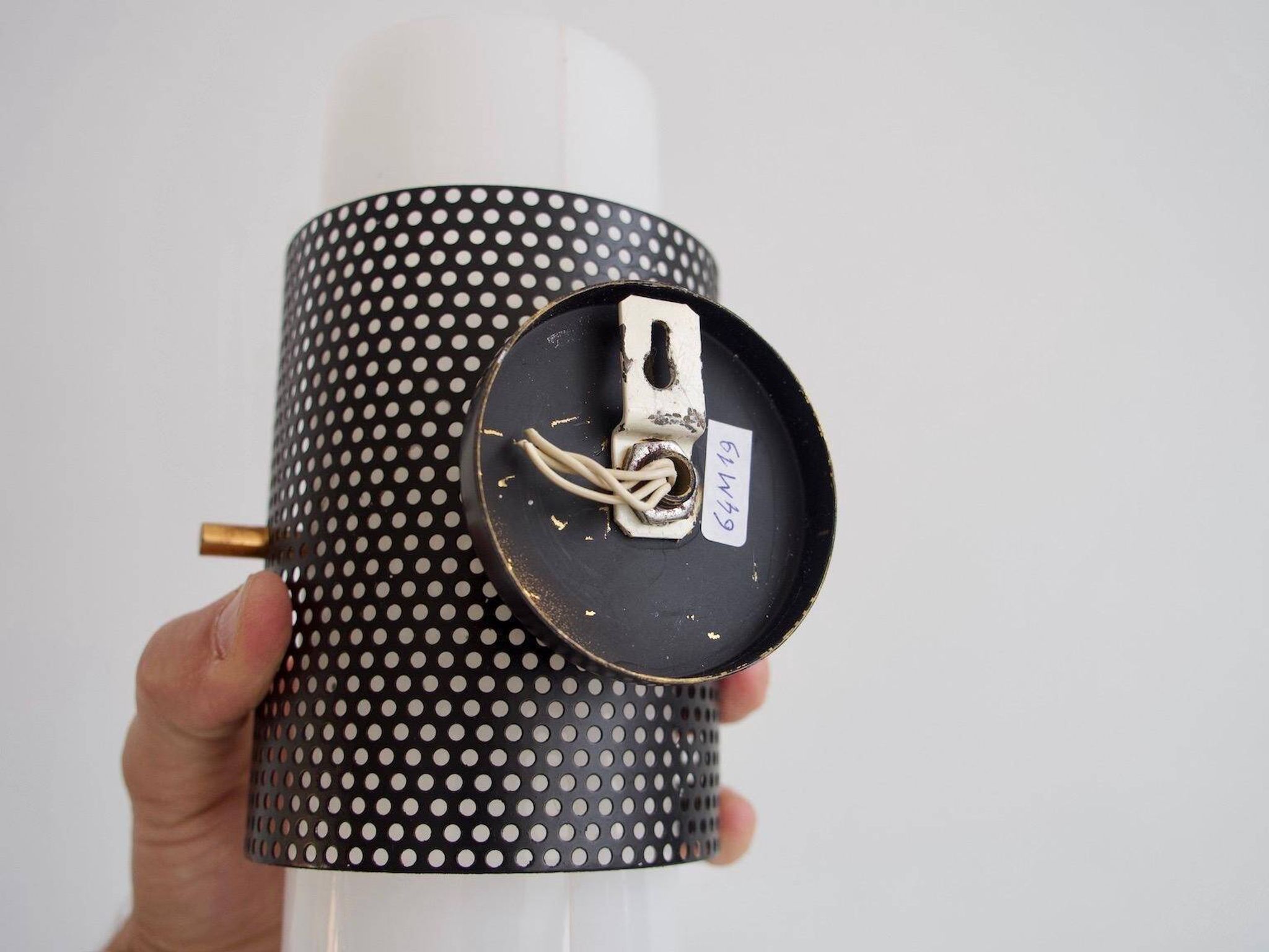 Set of four wall lights in white plexiglass and perforated black metal.
